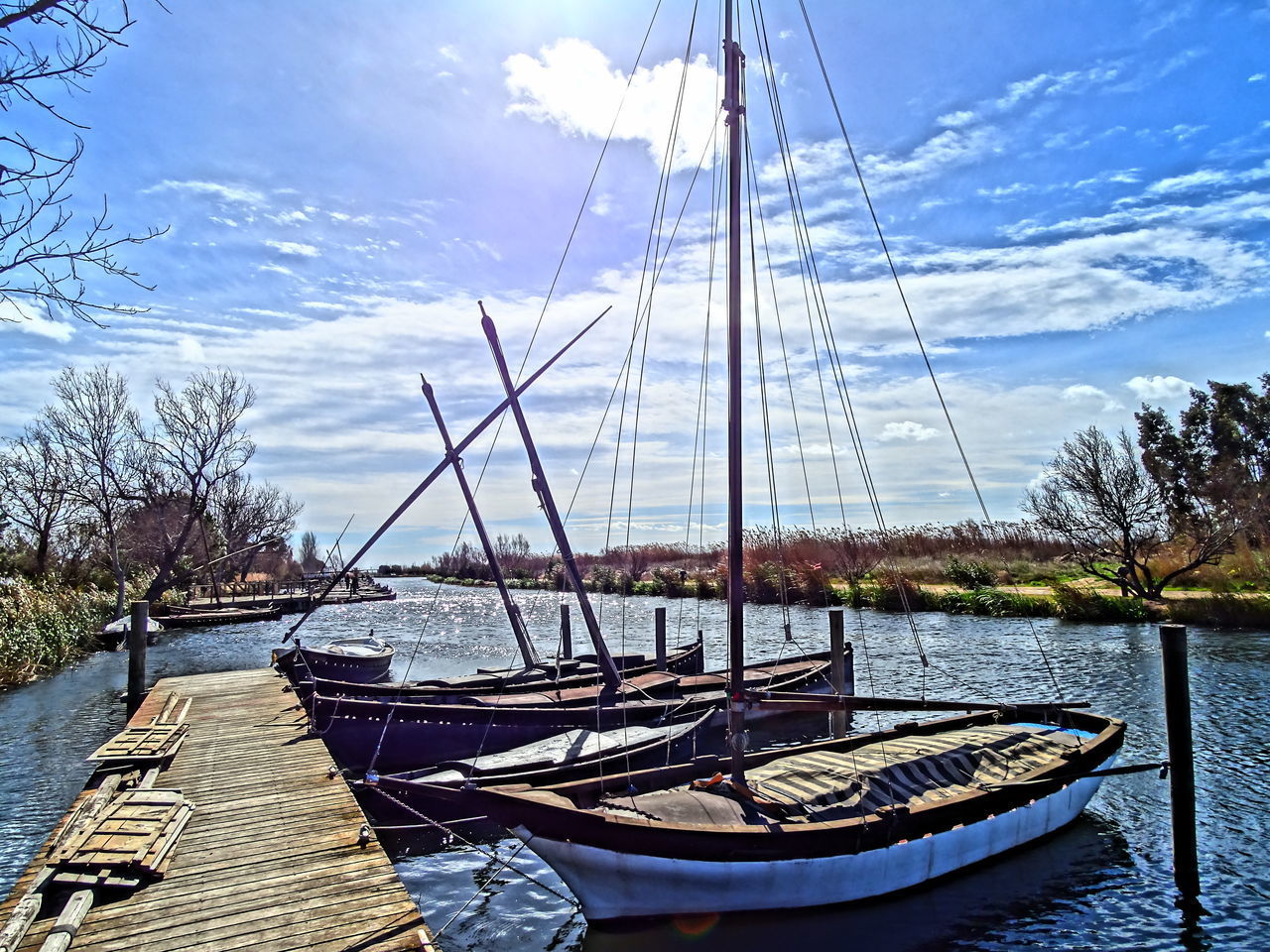 BOAT MOORED IN SEA AGAINST SKY