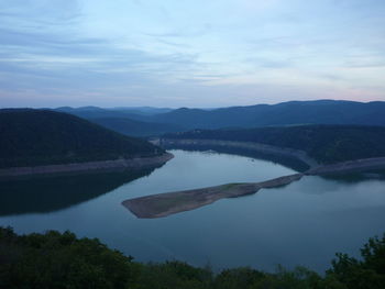 Scenic view of lake and mountains against sky