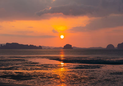 Beautiful sunset on the beach in summer with reflection of the sun in water