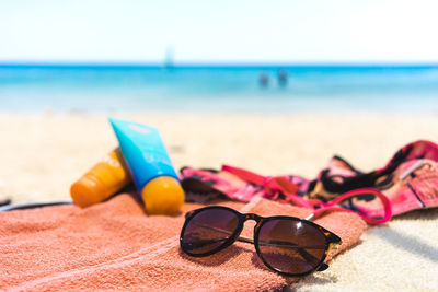 Close-up of sunglasses on beach