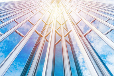 Low angle view of glass building against sky