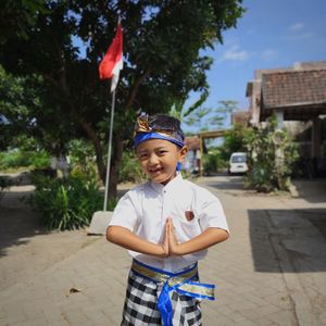 Boys posing in traditional balinese costumes to celebrate indonesia's independence day 