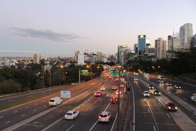 High angle view of traffic on road by buildings against sky