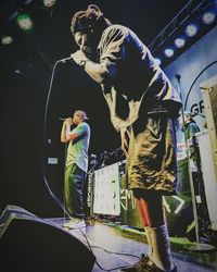 People standing on stage at night