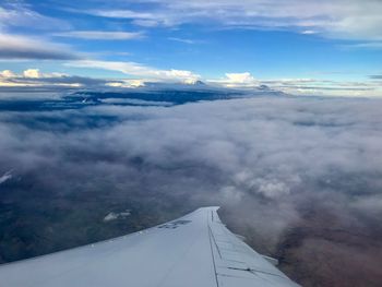Aerial view of aircraft wing against sky