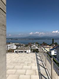 Scenic view of sea by buildings against sky