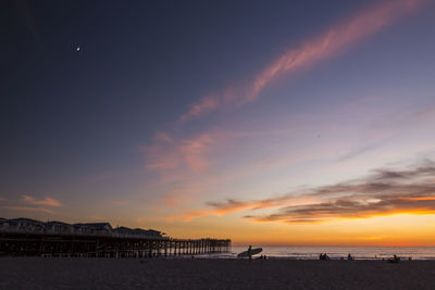 Scenic view of beach against sky during sunset