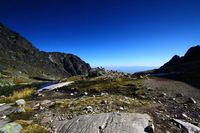 Scenic view of mountains against clear blue sky