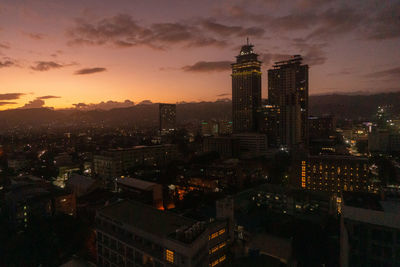 High angle view of illuminated buildings against sky during sunset