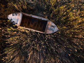 High angle view of abandoned boat amidst plants on field