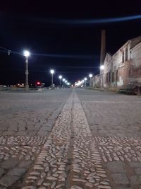 Street amidst illuminated buildings in city at night