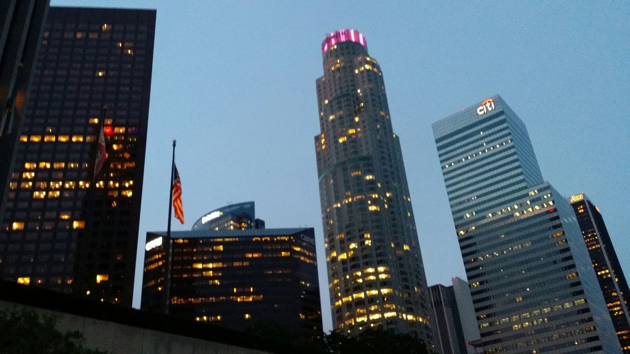 architecture, building exterior, built structure, skyscraper, city, tall - high, tower, modern, office building, low angle view, capital cities, illuminated, travel destinations, financial district, famous place, city life, night, clear sky, tall, sky