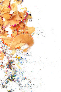 High angle view of multi colored pencils against white background