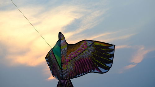 Low angle view of statue against sky during sunset