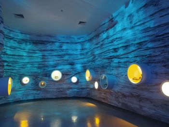 Reflection of illuminated lights in swimming pool at night