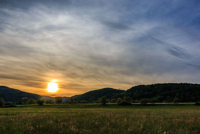 Scenic view of landscape against sky at sunset