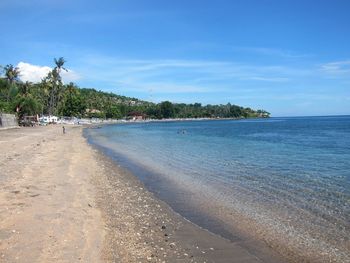 Scenic view of beach against blue sky