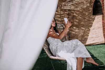 Midsection of woman lying on grass