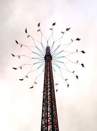 Low angle view of ferris wheel against sky