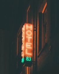 Illuminated text on wall at night