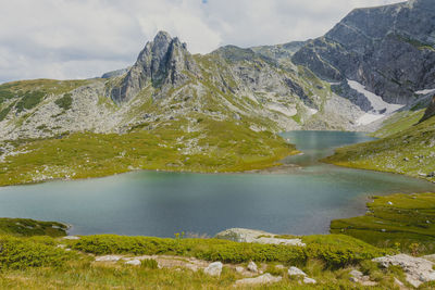 Scenic view of lake and mountains against sky