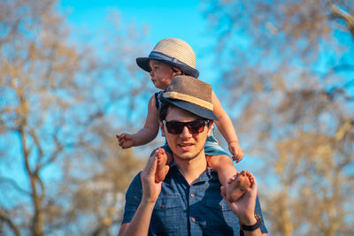 Close-up of man and boy against trees