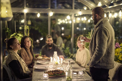 Happy friends having evening meal together