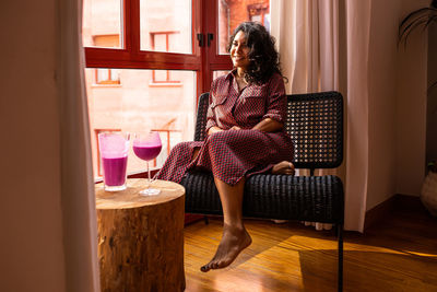 Woman sitting on chair at home