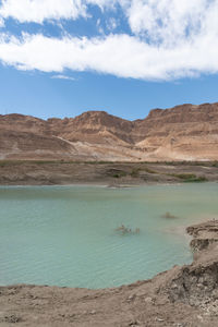 Sinkhole filled with turquoise water, near dead sea coastline a hole formed when underground salt is