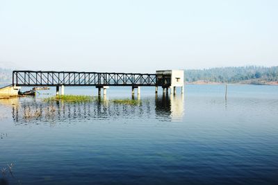 Pier over sea against clear sky