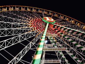 Low angle view of ferris wheel against sky at night