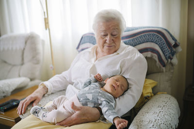 Great grandmother taking care of her great granddaughter at home