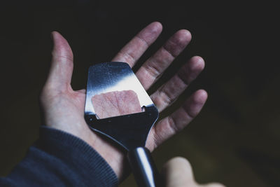 Close-up of hand holding cigarette