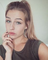 Close-up portrait of beautiful young woman over white background