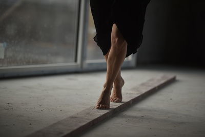 Low section of woman standing on floor