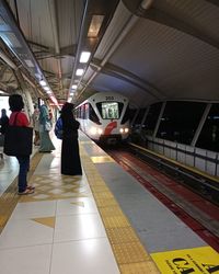 People waiting at railroad station platform