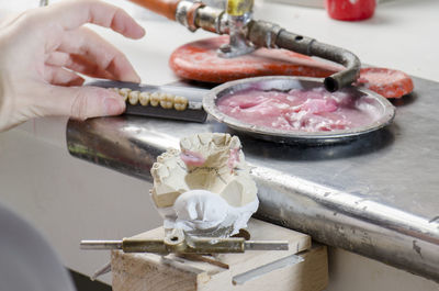 Close-up of man working on metal