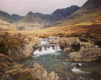 Scenic view of stream flowing through rocks