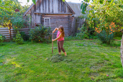 Full length of woman standing in yard