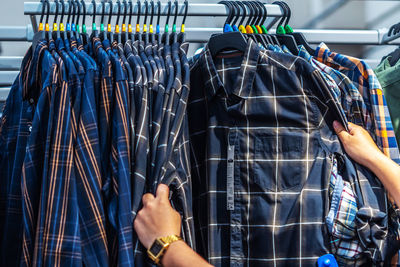 Midsection of man in shopping cart at store