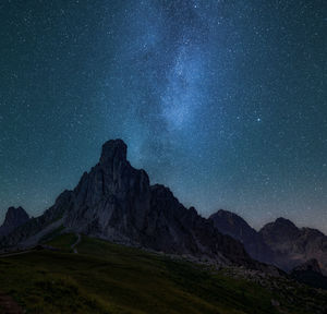 Scenic view of mountains against sky at night