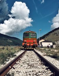 Train on railroad track against sky