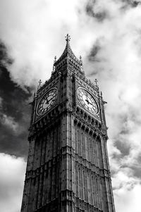 Low angle view of tower against cloudy sky