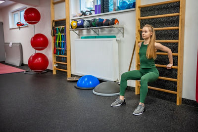 High angle view of man exercising with dumbbells on table