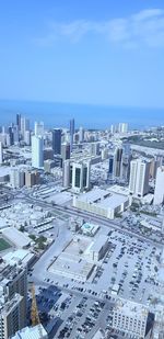 High angle view of buildings by sea against sky