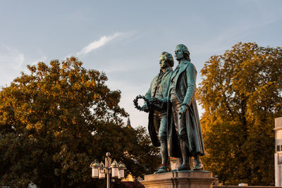 Low angle view of statue against trees