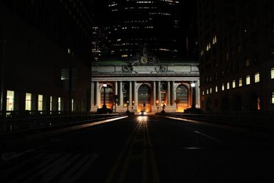 Illuminated tunnel at night