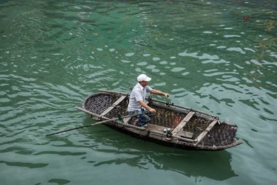 High angle view of man rowing boat in sea