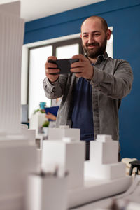 Portrait of young man using mobile phone