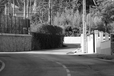 Road by trees against sky